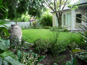 A Curved lawn complements the modern addition to the rear of this classic villa